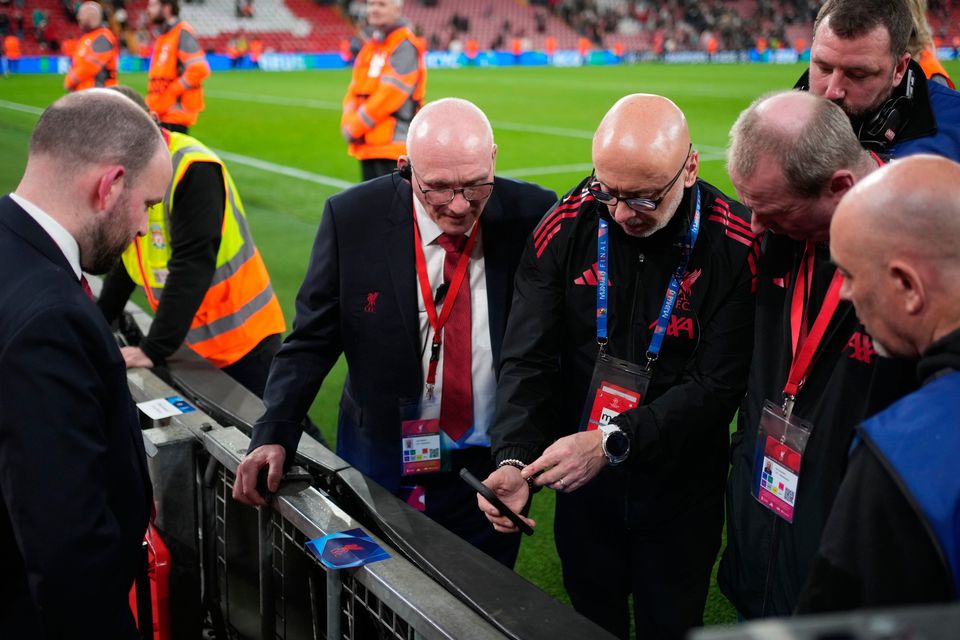 Officials inspect advertising hoarding where Galatasaray's Noa Lang hurt his thumb.