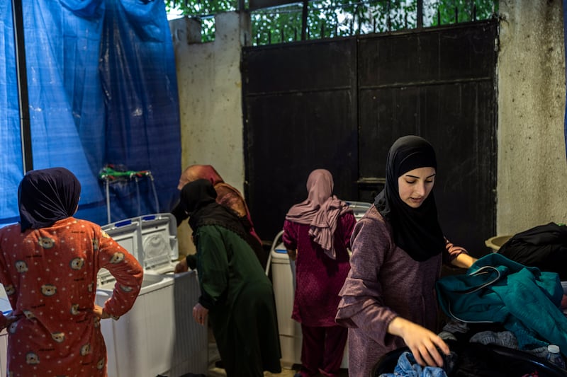 Displaced women wash clothes at a temporary shelter at a school in Beirut, Lebanon. Photograph: Diego Ibarra Sánchez/The New York Times
                      