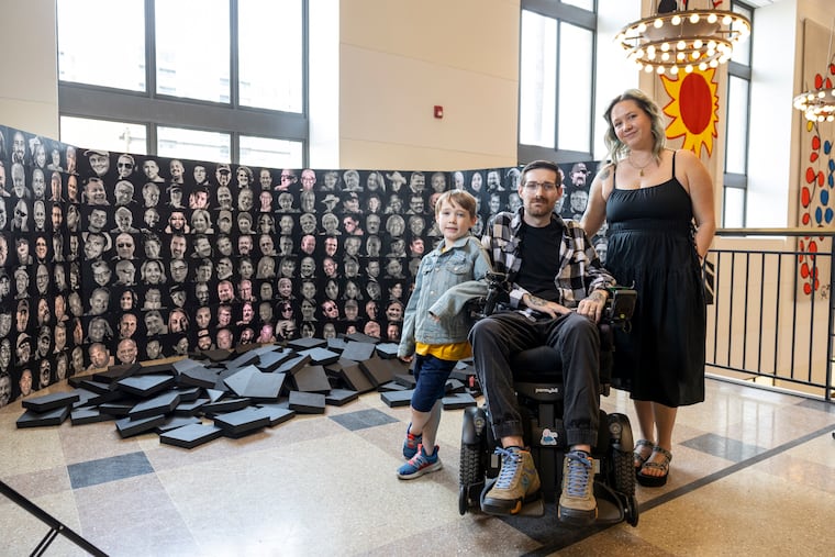 Eric Brunner, 39, of South Philadelphia, poses for a portrait with his wife Allie Brunner, 36, and their son Logan, 7, with Eric’s 3D printed art piece at the Free Library of Philadelphia Parkway Central Library in Philadelphia, Pa., on Wed., March. 11, 2026.