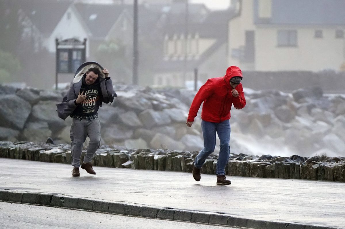 People walking in high winds at Salthill, Galway 