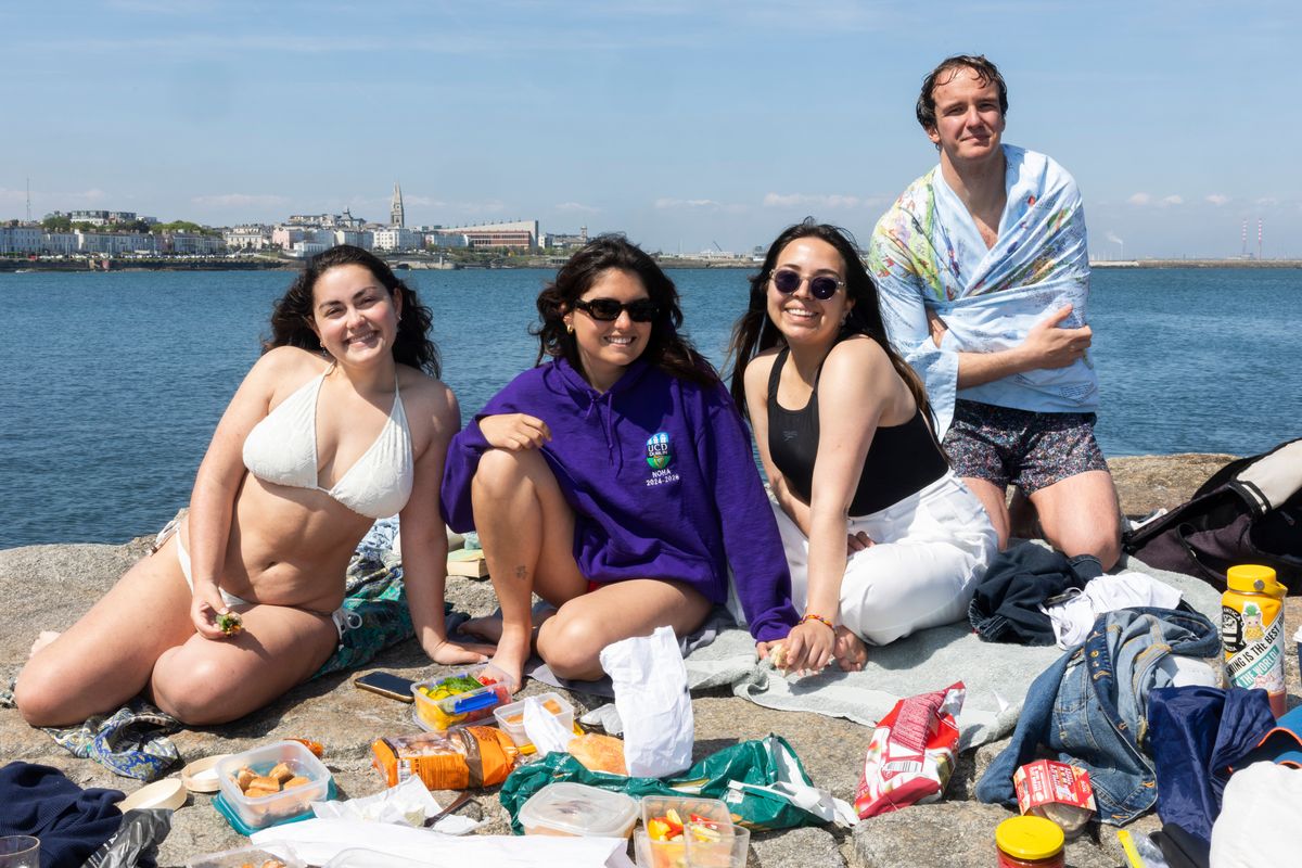 09/05/2025 - (Lto R) Elsa, Marta, Anna and Leo from Italy enjoying a picnic in the sun at Sandycove, Dublin 