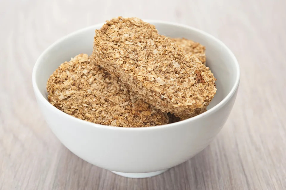Shot of Weetabix in a white bowl on a table.