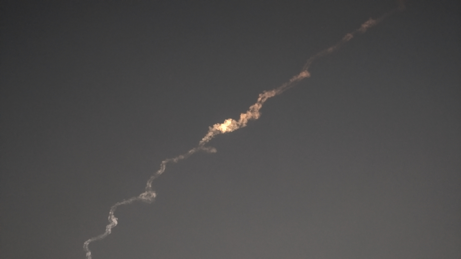 Photo of the illuminated smoke trail of the fireball meteor