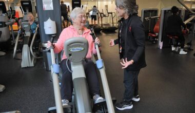 Gillian Phillips, 86, uses a NuStep machine while sharing a laugh with Karen Price, general manager of the Bob Chan-Kent Family YMCA, in Chilliwack on March 19, 2026. (Jenna Hauck/ Chilliwack Progress)