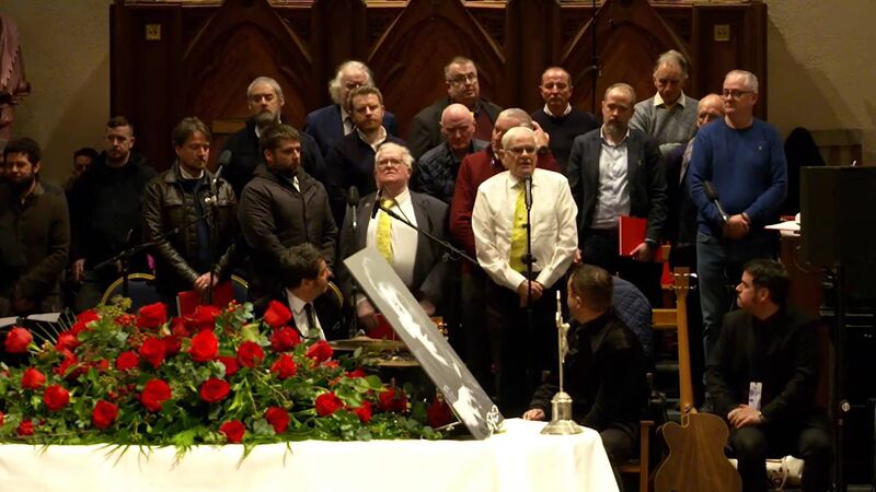 Séan Ó Sé and Cór Cúil Aodha performing at Shane MacGowan's funeral in Nenagh in 2023.
