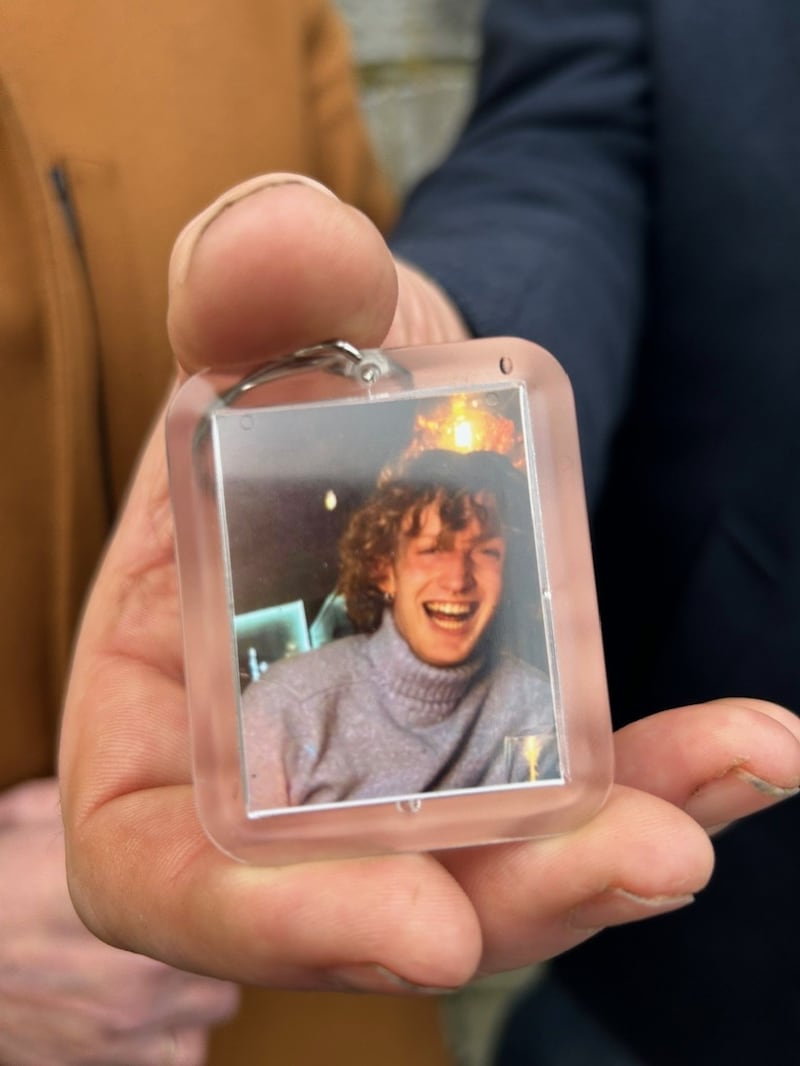 A member of his family holding a keyfob with a photograph of Joe Drennan outside Limerick Circuit Court.