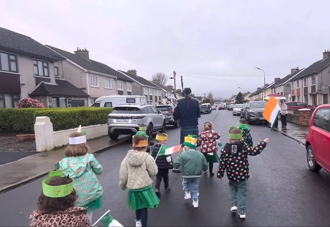 Twenty pupils attending the Busy Bees pre-school, at Park Gardens, Corbally, Limerick, marched alongside a local piper, Paul McMahon, five hundred metres to a roundabout, and back to their classroom. Picture: David Raleigh