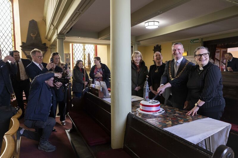 Lord Mayor of Cork, Cllr Fergal Dennehy, and Reverend Meghan Farr cutting a cake that was made by a member of the congregation. Picture: Clare Keogh 