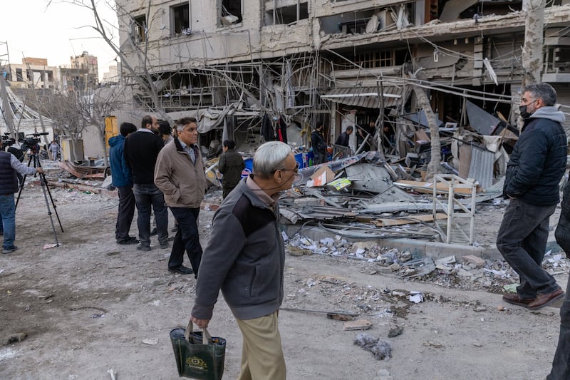 People view damage to shops and residences destroyed by an air strike on Monday in Tehran, Iran. Photograph: Majid Saeedi/Getty