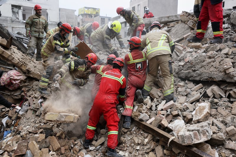 Rescue workers search for survivors in the rubble after a strike in southern Tehran, Iran. Photograph: Sajjad Safari/AP