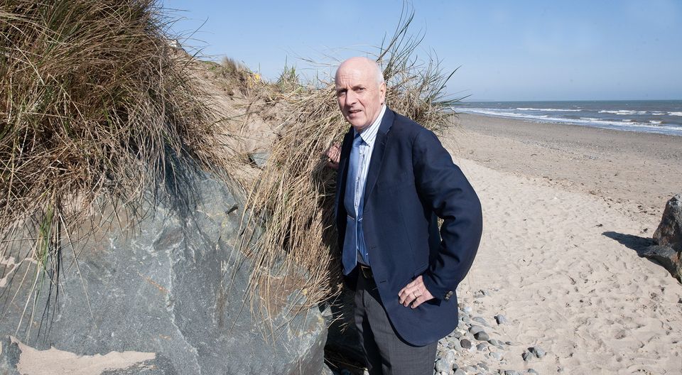 Billy Kelly at the area behind Kelly's Resort Hotel where the erosion is evident.  Photo: Jim Campbell


