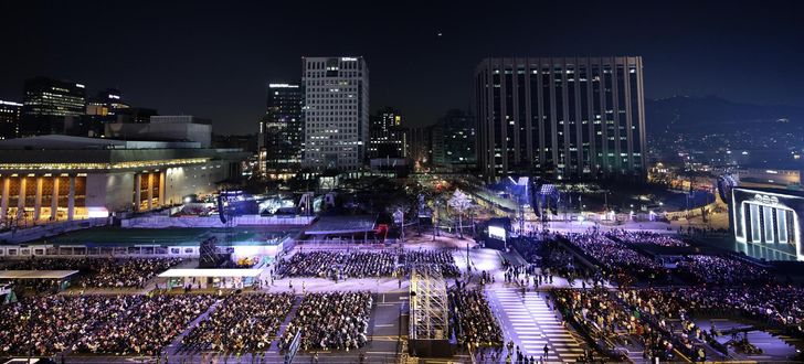 BTS fans are seated at the concert venue at Gwanghwamun Square in Seoul, March 21, before the comeback concert. Joint Press Corps