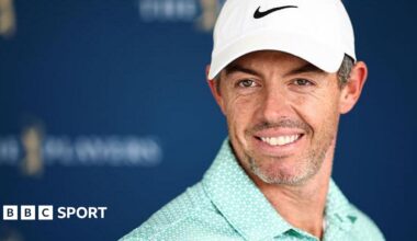 Rory McIlroy wearing a baseball cap and smiling