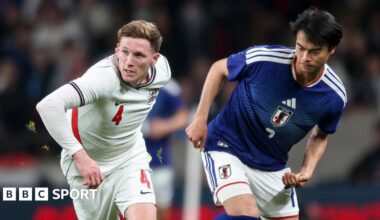 Elliot Anderson of England holds off Kaoru Mitoma of Japan during the international friendly match at Wembley Stadium