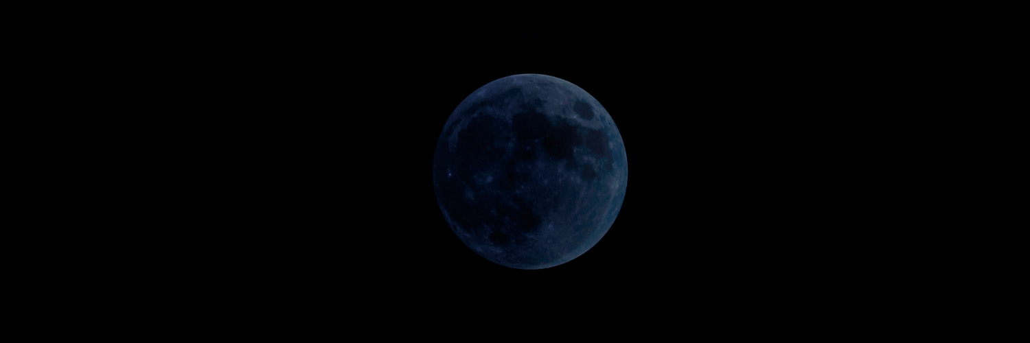 new moon in the dark sky