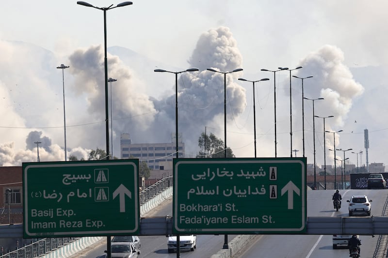 Vehicles drive along an expressway against the backdrop of smoke rising after a strike on the Iranian capital of Tehran on March 5th, 2026. Photograph: ATTA KENARE / AFP via Getty Images