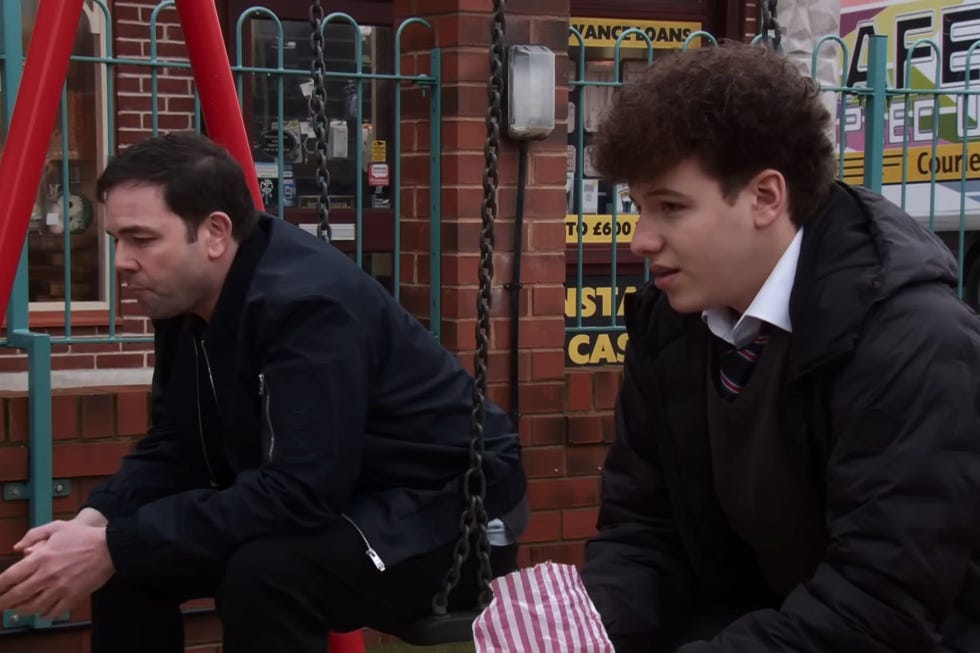 coronation street, ben and will driscoll sat outside on the swings