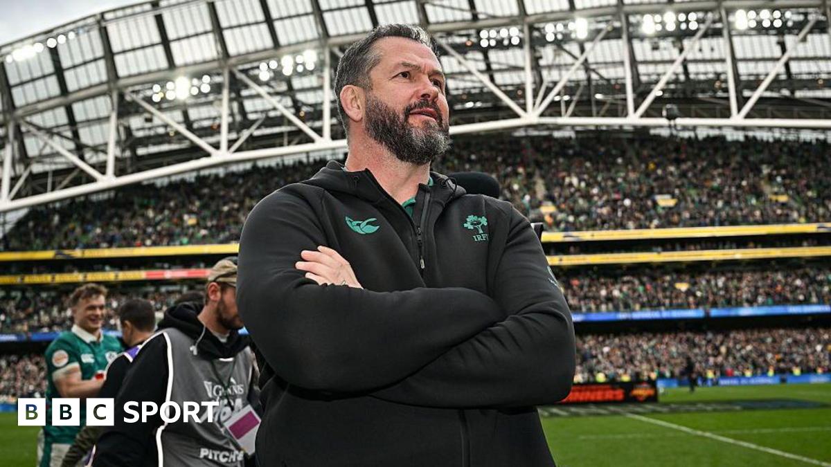 Andy Farrell stands with his arms folded inside Aviva Stadium, wearing an Ireland team fleece top