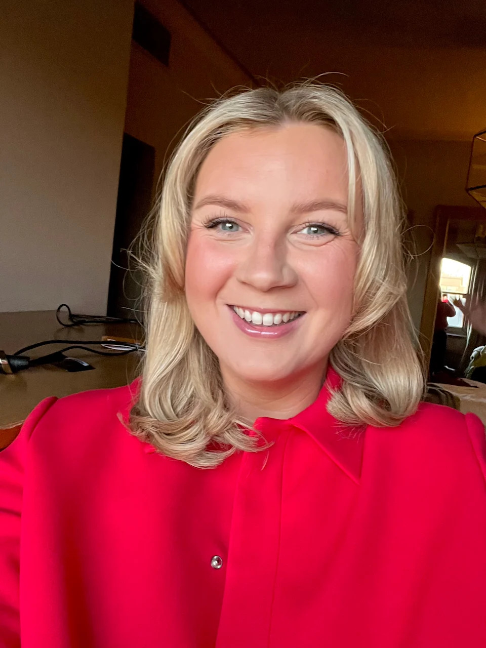 Katie smiling in a selfie and red top