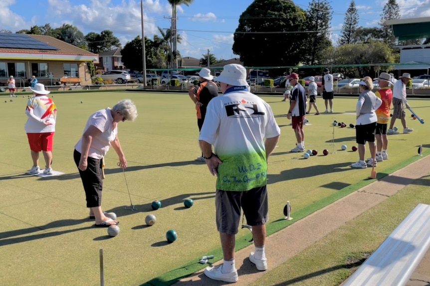 A group of people playing lawn bowls