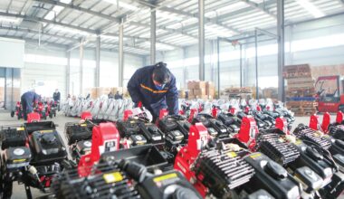 Workers inspect mini tillers bound for India at an agricultural machinery company in Yongchuan, Southwest China
