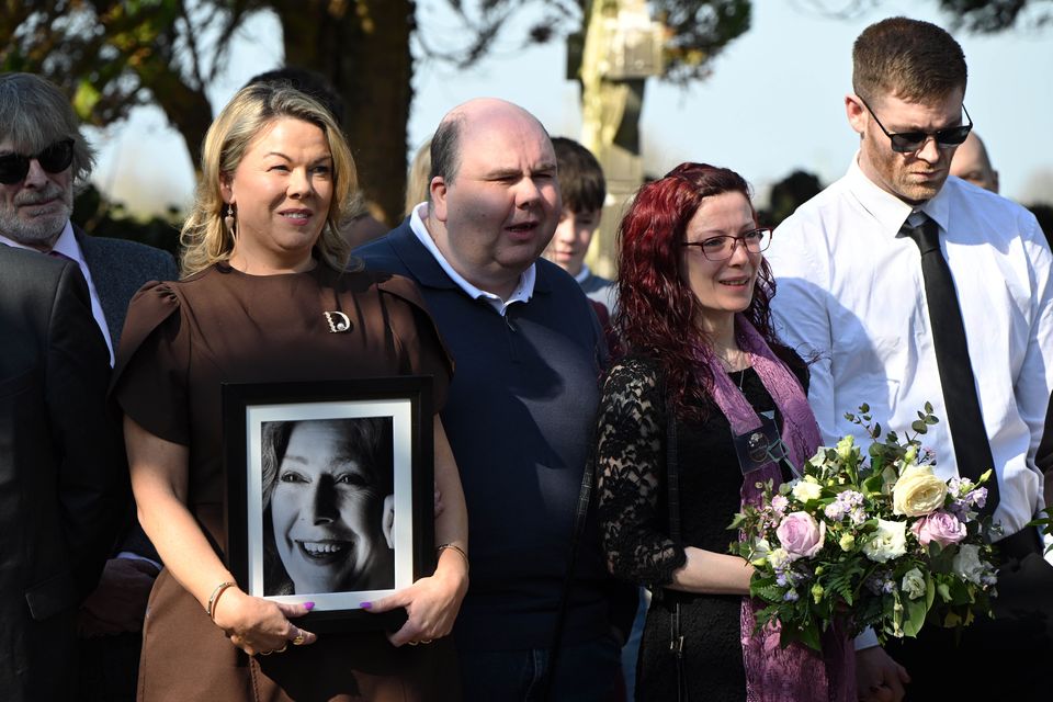 Dolores Keane’s son Joseph (second from left) and her daughter Tara (with flowers) arrive for the funeral of their mother and sister Dolores Keane at Kilcoona church. Photo: Ray Ryan