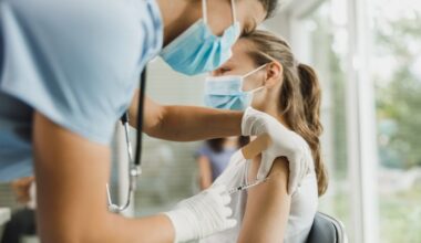 Clinician preparing RSV vaccination for an immunocompromised patient during a respiratory virus season visit.
