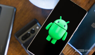 Android robot on smartphone next to other devices and accessories (2)