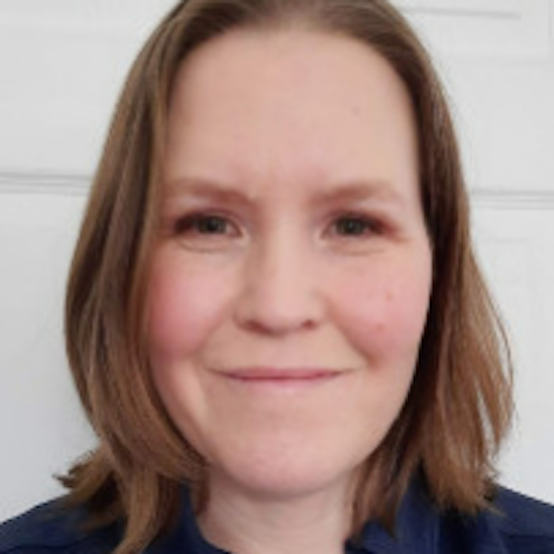 Smiling woman with long brown hair.