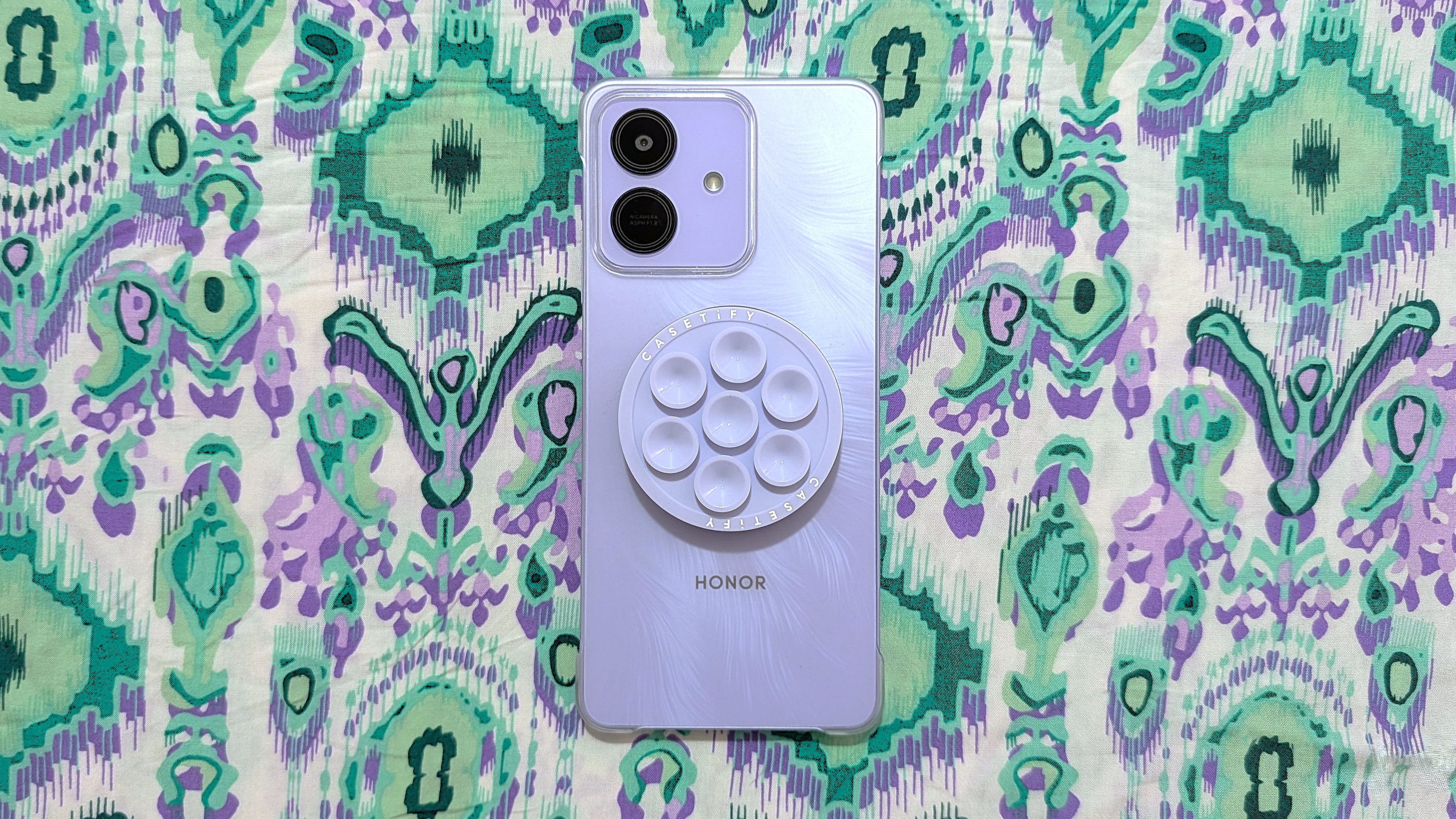 Honor Play 10 with a clear case, a magnetic ring sticker, and MagSafe accessories.