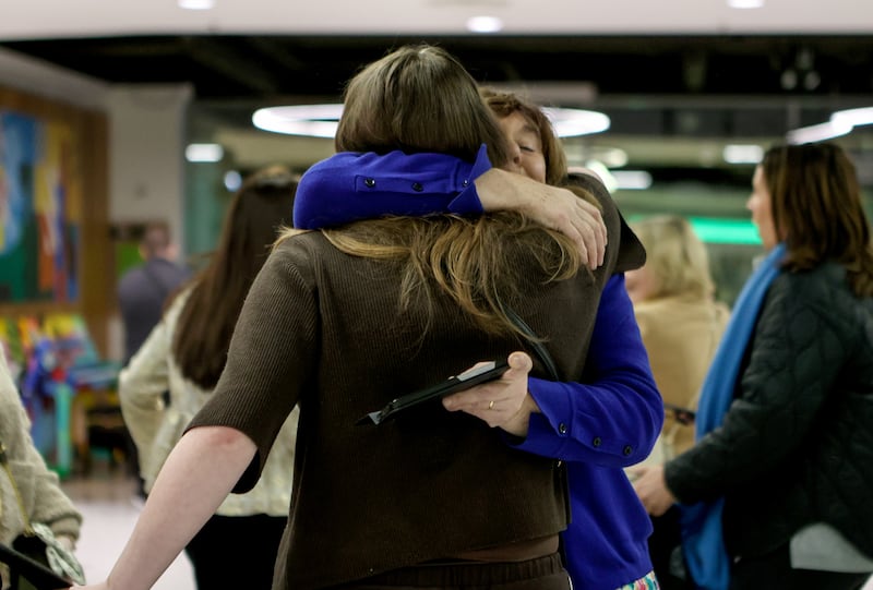 Passengers are welcomed by family members as they arrive at Dublin Airport following an Irish Government chartered flight from Oman, which stopped at Cairo, before touching down in Dublin in the early hours of Sunday. Photograph: Evan Treacy/PA Wire 