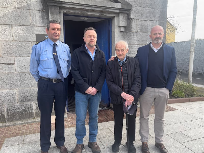 Garda Thomas Duane with Stephen O'Callaghan's brothers Emmet and Keith and father John outside Cork County Coroner's Court in Midleton. Photograph: Olivia Kelleher