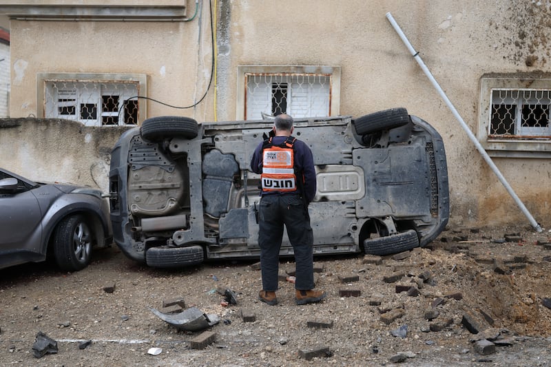 A man surveys the damage to a car following a projectile strike in the Arab-Israeli city of Kfar Qassem on Thursday. Photograph: Ilia Yefimovich/AFP via Getty Images 