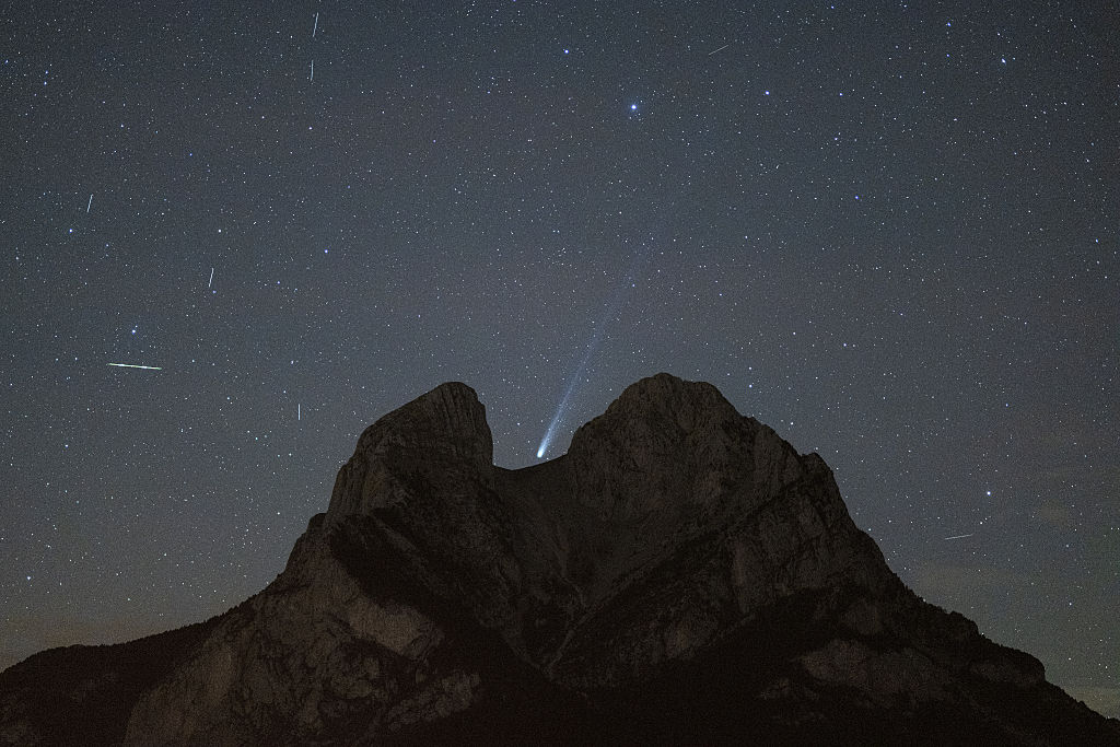 The comet C/2019 U6 (Lemmon), discovered on October 31, 2019, from the Mount Lemmon Observatory in Arizona, streaks across the night sky behind Pedraforca mountain in the Bergueda region in Spain on October 24, 2025. The comet, composed mainly of ice and dust, was named after the observatory where it was first detected, part of the Catalina Sky Survey program dedicated to tracking near-Earth objects. Pedraforca, located within the Cadi-Moixero Natural Park, is one of Spain's most iconic mountains, recognized for its distinctive double peak and symbolic importance to Catalan mountaineering. (Photo by Lorena Sopena/Anadolu via Getty Images)