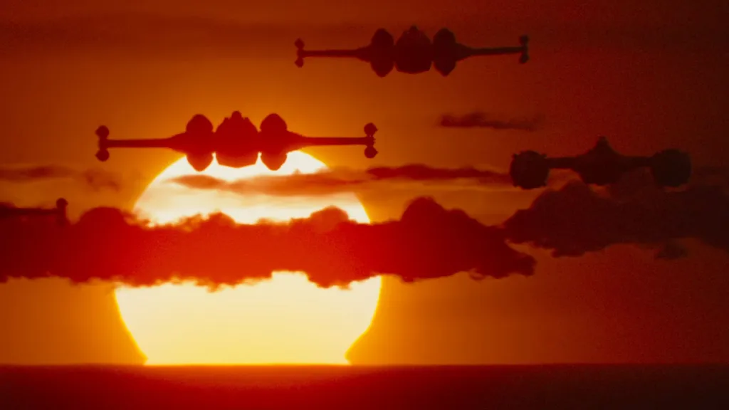 Din Djarin flying his modified Naboo N-1 Starfighter in close formation with a New Republic squadron in Star Wars The Mandalorian and Grogu