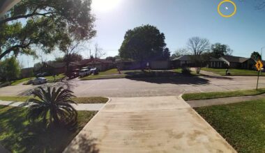 Doorbell camera photo of a fireball meteor streaking in the sky over a residential area