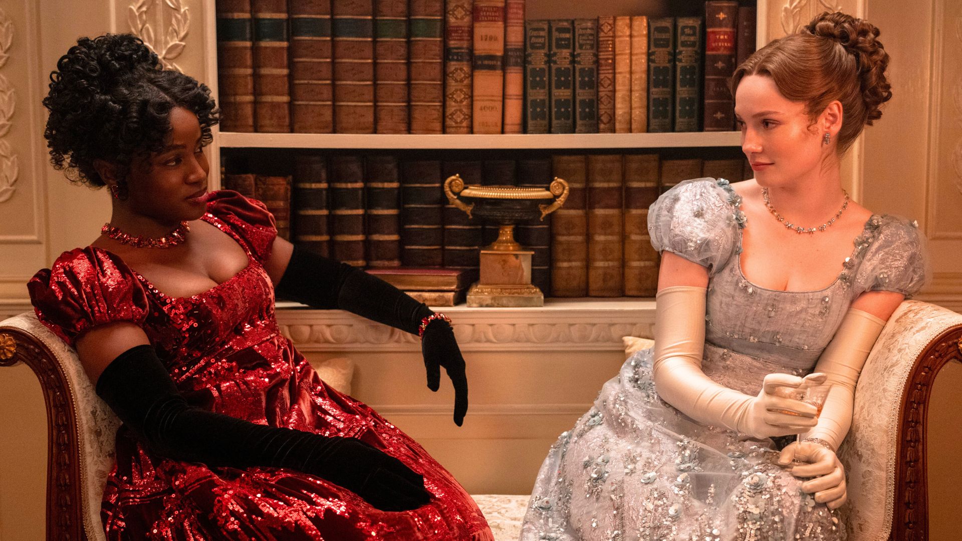 Francesca and Michaela look at each other from across a sofa