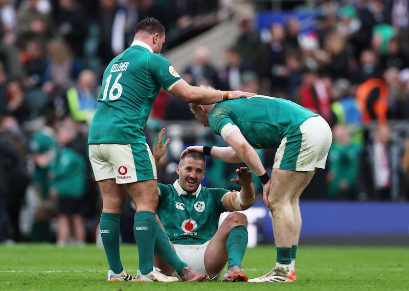 Ireland's Stuart McCloskey celebrates victory with teammates Rónán Kelleher and Jamie Osborne at Twickenham on February 21st. Photograph: Steve Bardens/RFU Collection via Getty Images