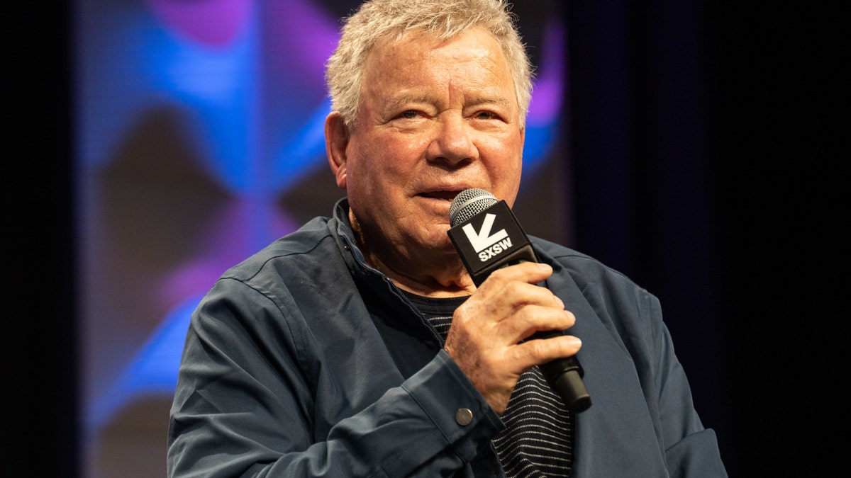 William Shatner speaking into a microphone