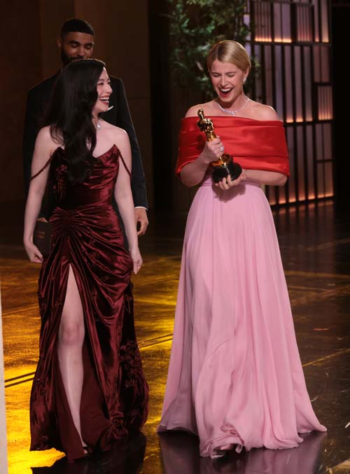 In this handout photo provided by The Academy, presenter Mikey Madison walks off stage with Jessie Buckley, winner of the Actress in a Leading Role award for "Hamnet", during the 98th Oscars at Dolby Theatre. Pic: Getty Images