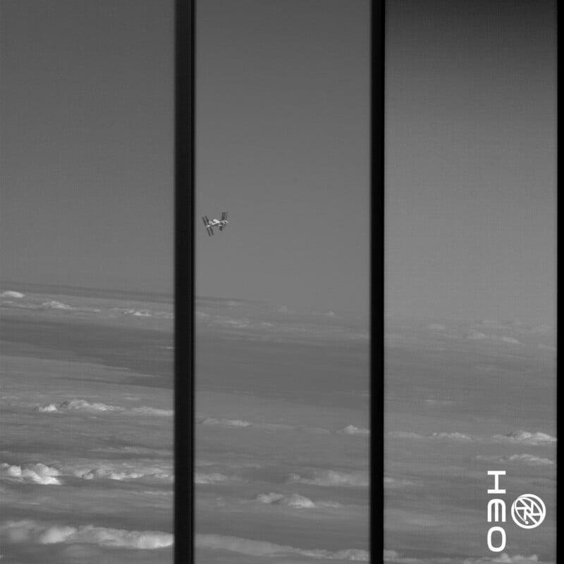 A small spacecraft or satellite floats in space above cloud-covered Earth, seen through three vertical window panes. The logo "NEO" is at the bottom right corner of the grayscale image.
