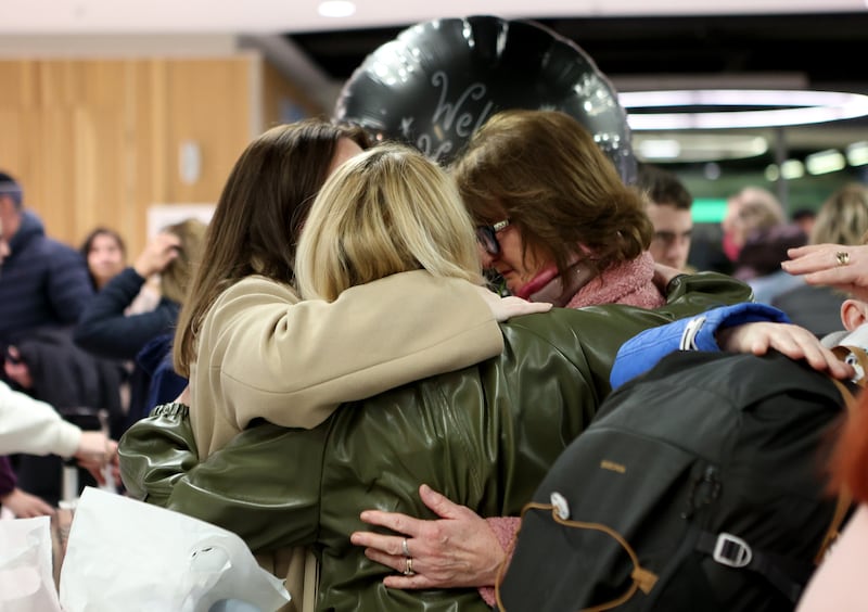 Passengers are welcomed by family members as they arrive at Dublin Airport following an Irish Government chartered flight from Oman, which stopped at Cairo, before touching down in Dublin in the early hours of Sunday. Photograph: Evan Treacy/PA Wire 