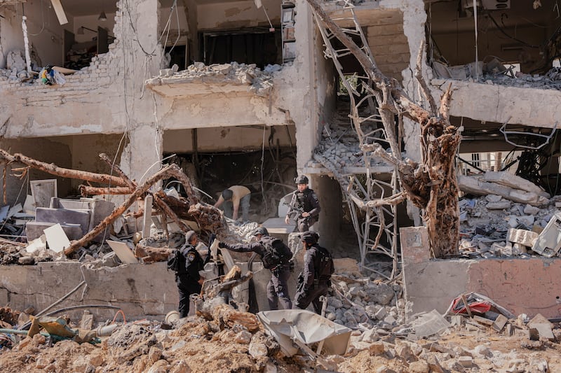 Israeli security officials inspect the site of an Iranian missile strike in Tel Aviv, Israel, on Sunday. Amit Elkayam/The New York Times                      