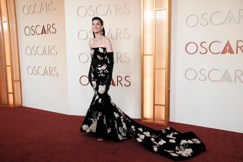Anne Hathaway sporting a fish-tail frock with some sleek, long black gloves. Photograph: Jutharat Pinyodoonyachet/New York Times