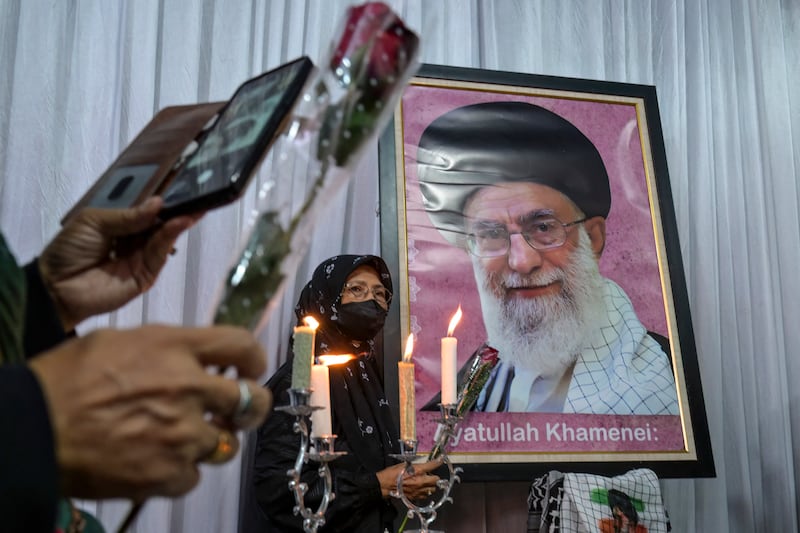 A mourner poses next to a portrait of Iranian supreme leader Ayatollah Ali Khamenei, who was killed amid US-Israel strikes, during the signing of a petition committing to international justice values, held at the Iranian Ambassador's residence in Jakarta on March 5th, 2026. Photograph: BAY ISMOYO / AFP via Getty Images