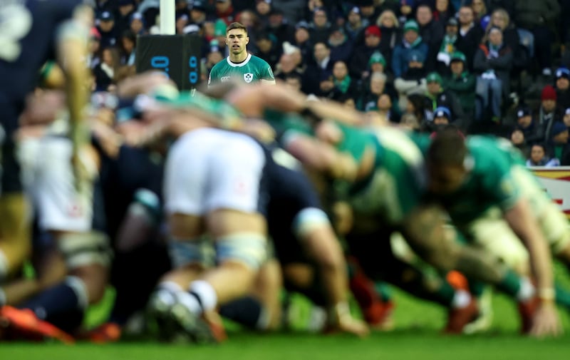 Ireland's Jack Crowley looks on as both teams slog it out in the scrum during last year's Six Nations match between Scotland and Ireland at Murrayfield. Photograph: Dan Sheridan/Inpho