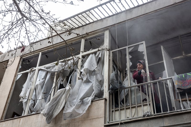 A woman cleans up in her apartment after an airstrike in Tehran, Iran. Photograph: Arash Khamooshi/The New York Times
                      
