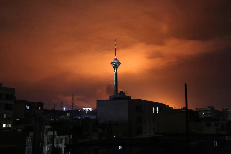 Milad Tower, the tallest tower in Iran at 435m, is backlit following air strikes on Tehran on Saturday night. Photograph: Atta Kenare/AFP via Getty