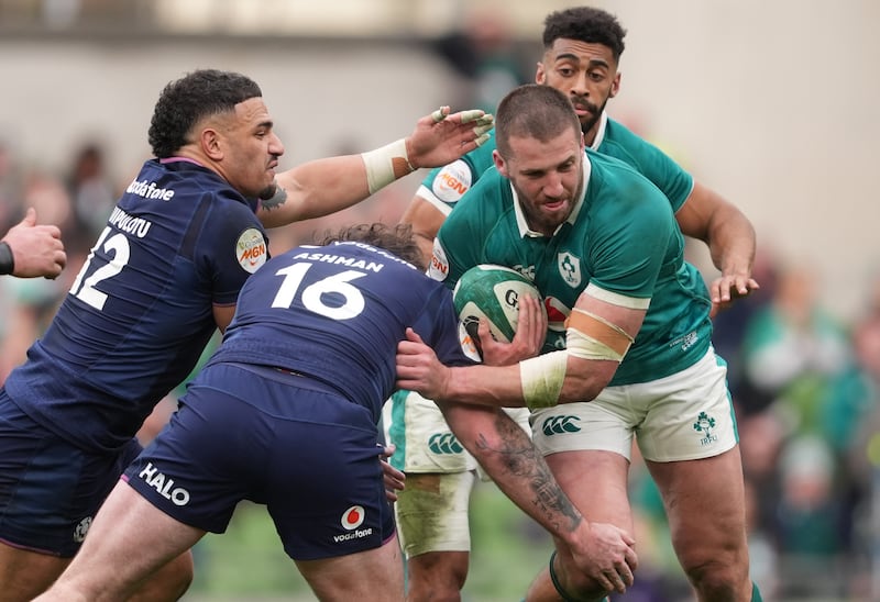 Ireland's Stuart McCloskey is tackled by Scotland's Ewan Ashman (centre) and Sione Tuipulotu. Photograph: Brian Lawless/PA