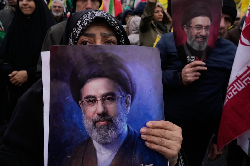 Demonstrators hold posters of Iranian supreme leader Mojtaba Khamenei in Tehran. Photograph: Vahid Salemi, AP